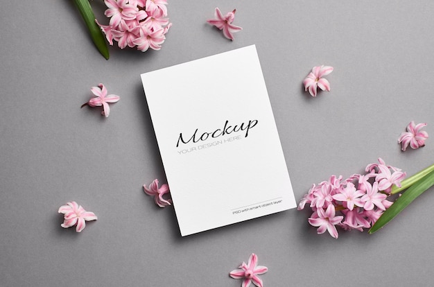 Greeting card mockup with spring pink hyacinth flowers on grey