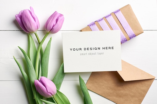 Greeting card mockup with tulip flowers, envelope and gift box