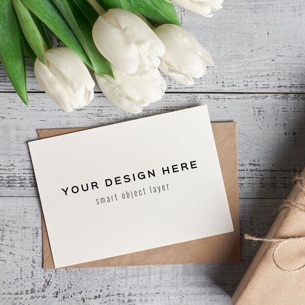 PSD greeting card mockup with tulip flowers and gift box