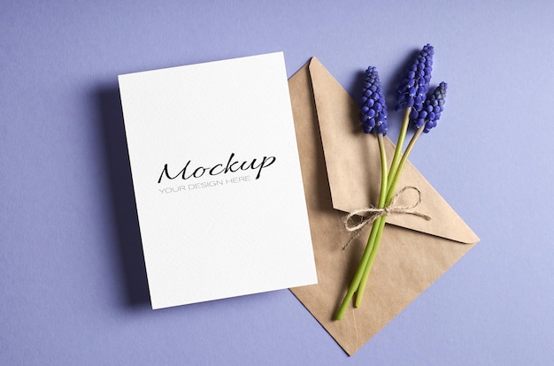 Greeting card stationary mockup with envelope and spring blue muscari flowers
