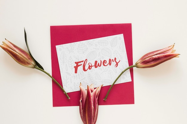 Greeting card with blooming flowers on table