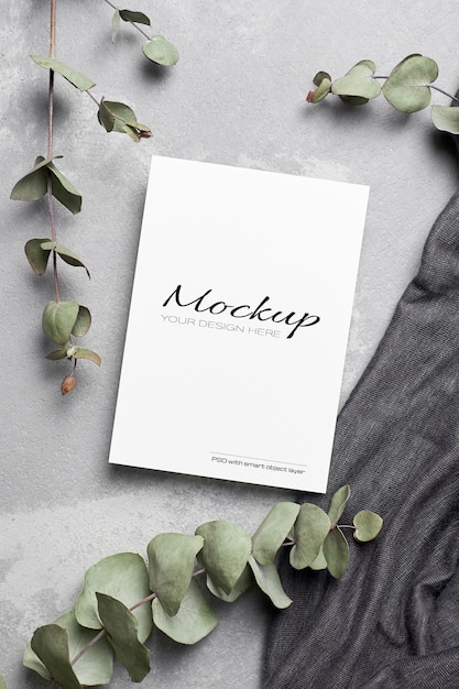 Greeting or invitation card mockup with dry eucalyptus twigs