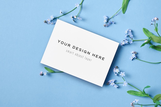 Greeting or invitation card mockup with flowers on blue