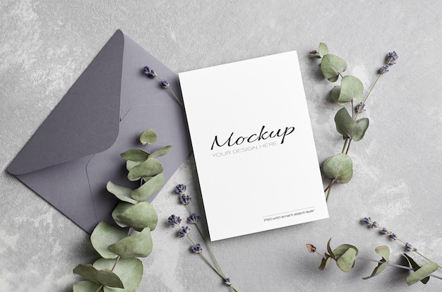 Greeting or wedding invitation card mockup with envelope, lavender and dry eucalyptus twigs