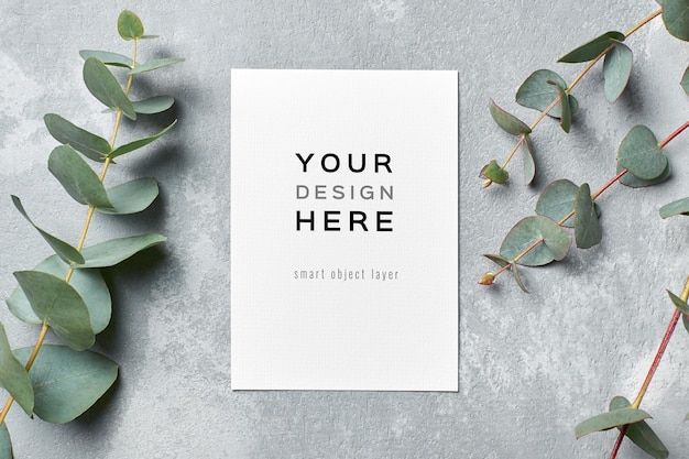 PSD greeting and wedding invitation card mockup with fresh eucalyptus twigs