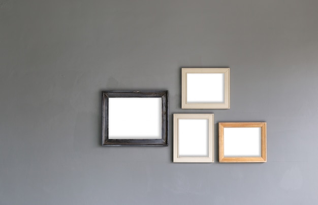 Group of blank photo frames on the wall for your design