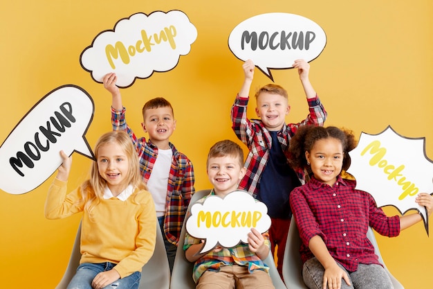 Group of children holding mock-up chat bubbles