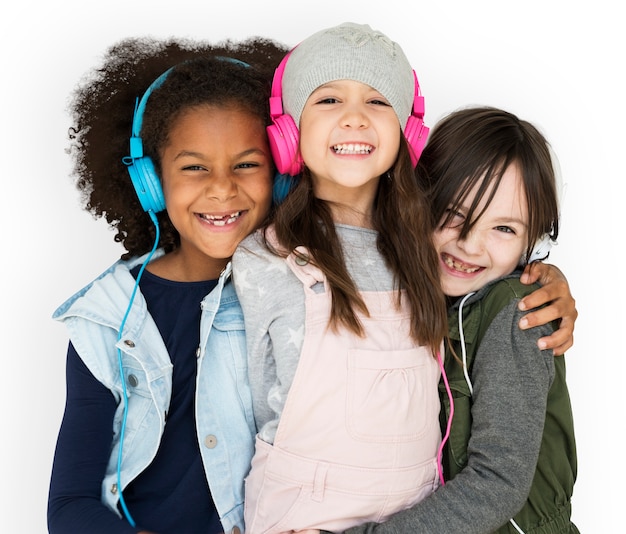 PSD group of little girls studio smiling wearing headphones and winter clothes