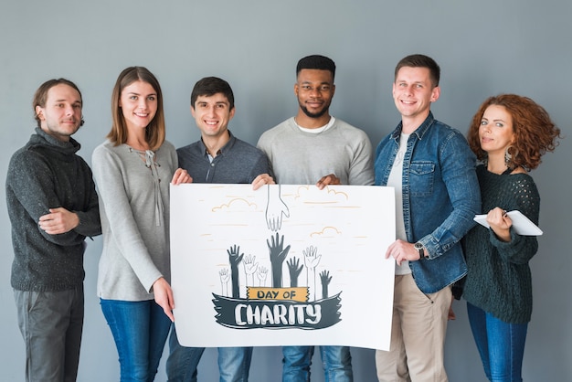 Group of people holding placard mockup for charity