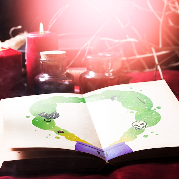 halloween desk decoration and book with melting pot drawing