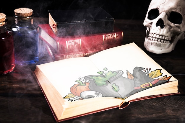 halloween desk decoration with open book and mist