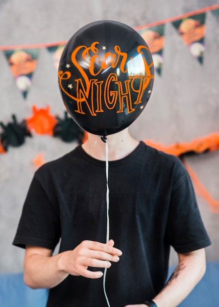 PSD halloween mockup with man holding balloon