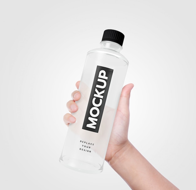 Hand hold bottle of water mockup