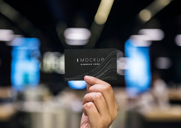 PSD hand holding a black business card mockup