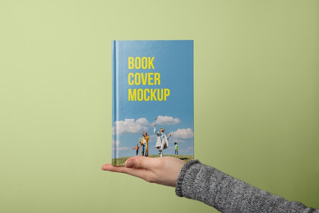 Hand holding  book mockup