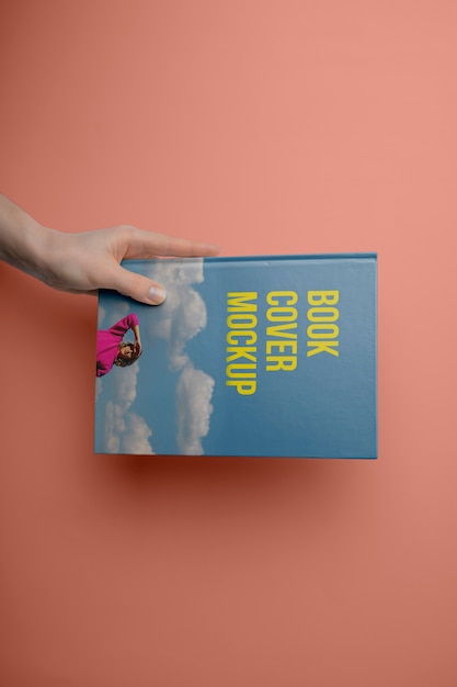 Hand holding  book mockup