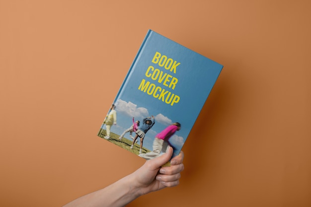 Hand holding  book mockup