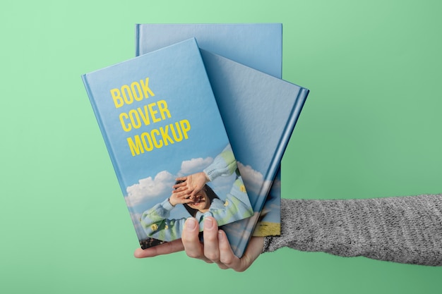 Hand holding  book mockup