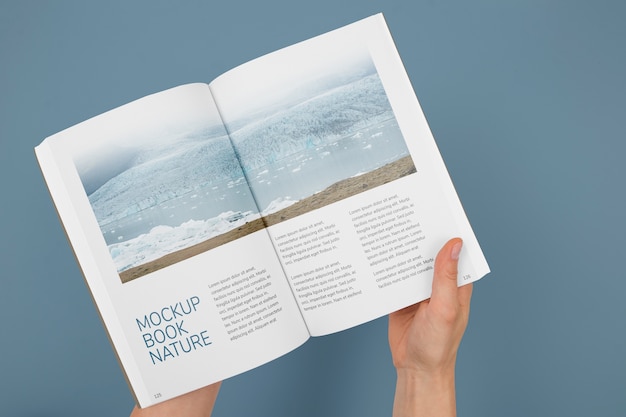 PSD hand holding book mockup