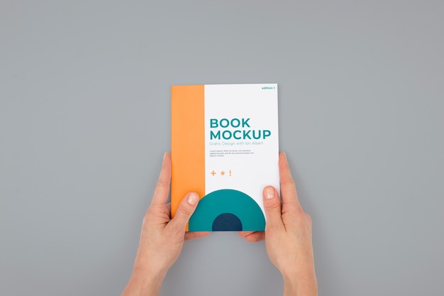 PSD hand holding book mockup