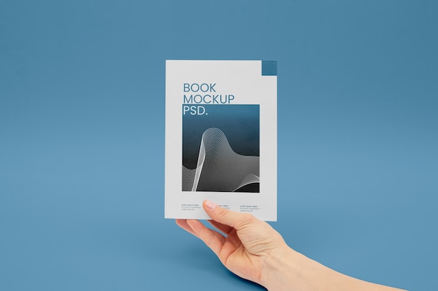 PSD hand holding book mockup