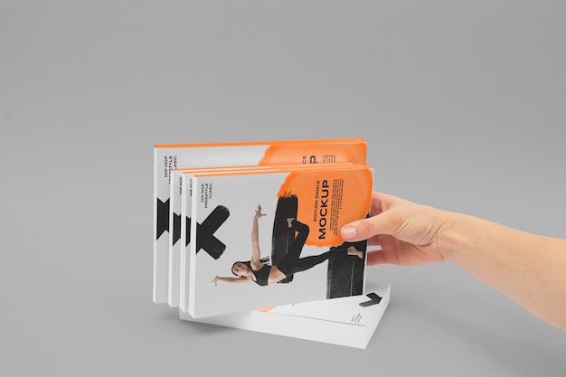 Hand holding book mockup