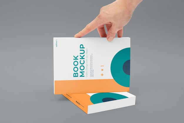 PSD hand holding book mockup