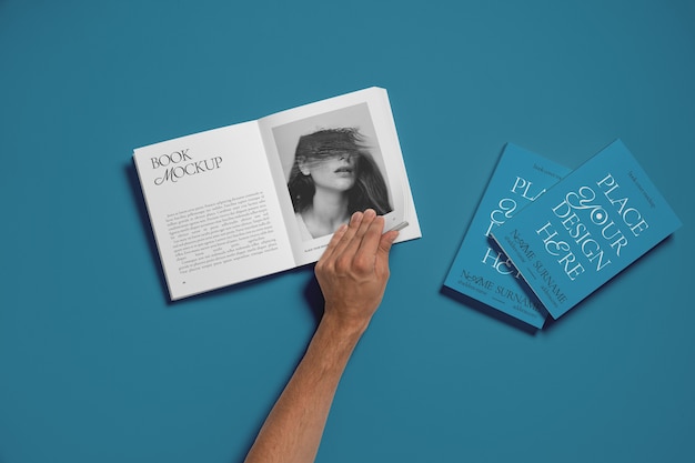 PSD hand holding book mockup