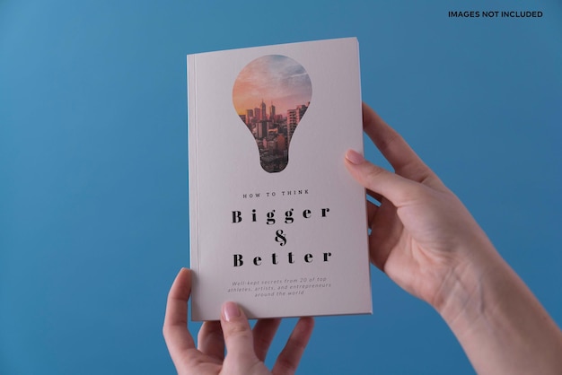 PSD a hand holding a book mockup