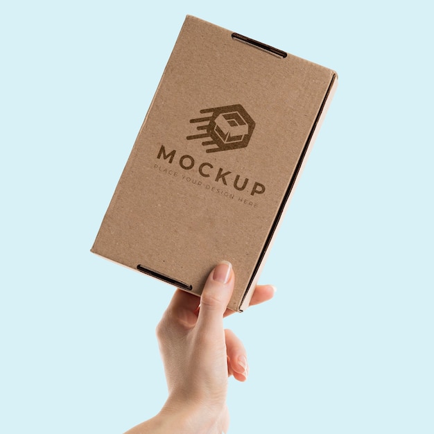 PSD hand holding a box mock-up