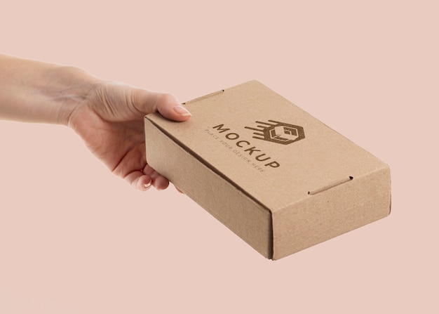 PSD hand holding a box mock-up