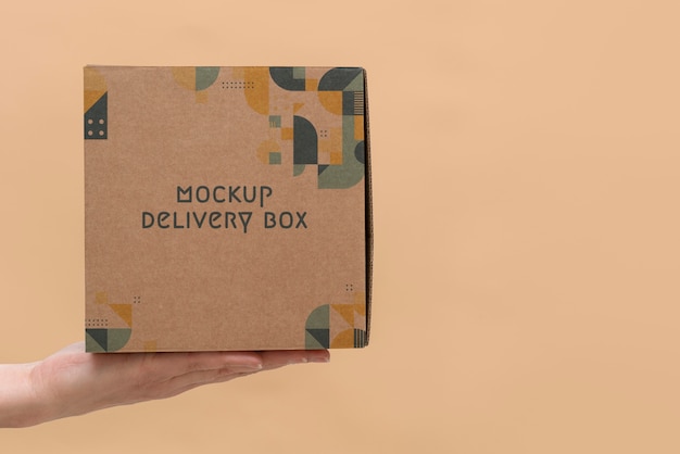 Hand holding box mockup