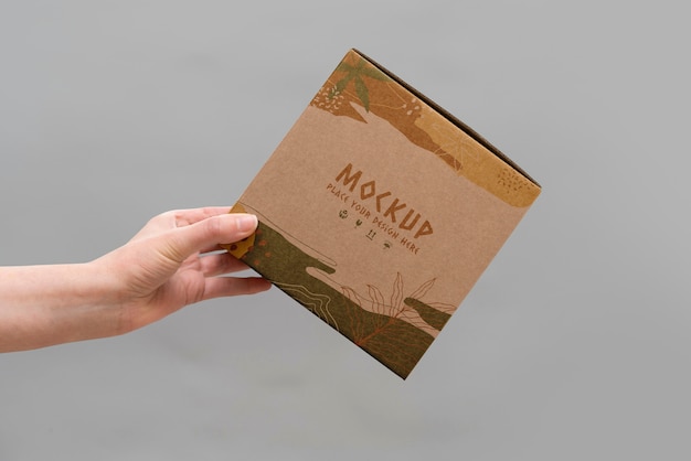 PSD hand holding box mockup