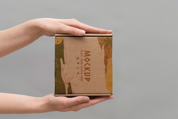 PSD hand holding box mockup