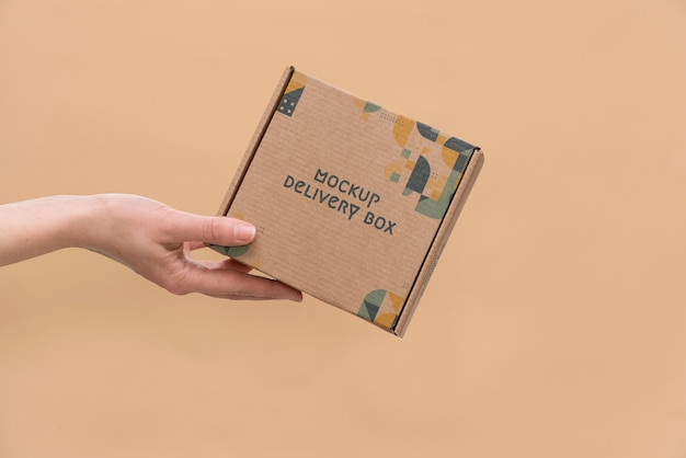 Hand holding box mockup