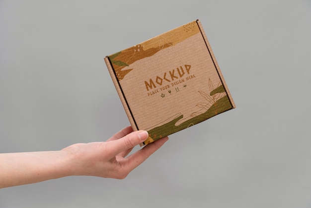 PSD hand holding box mockup