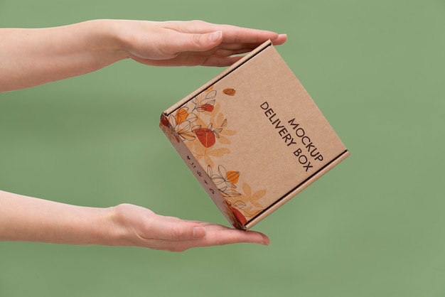 Hand holding box mockup