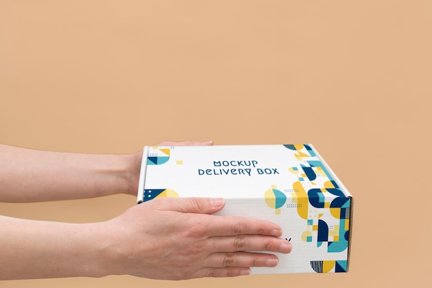 Hand holding box mockup