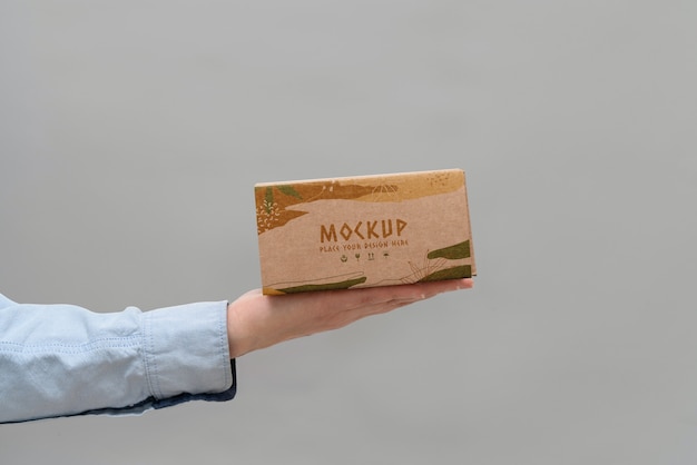 PSD hand holding box mockup