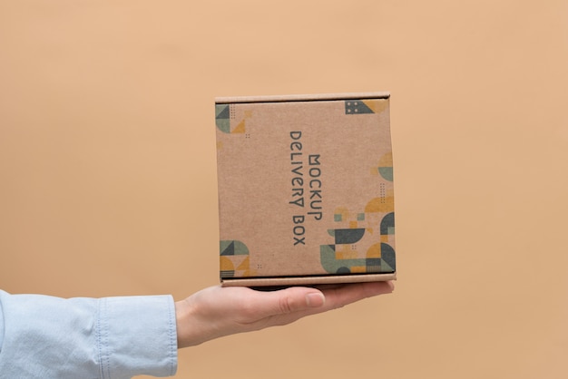 PSD hand holding box mockup