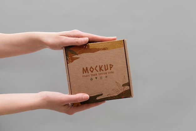 PSD hand holding box mockup