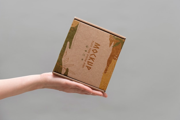 PSD hand holding box mockup