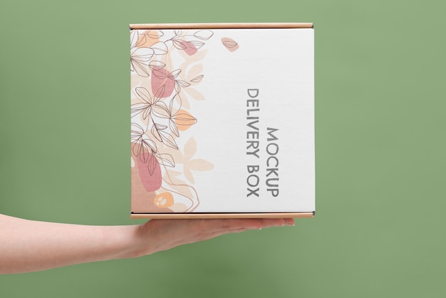 Hand holding box mockup