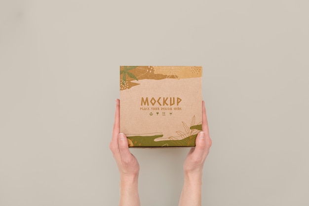 PSD hand holding box mockup