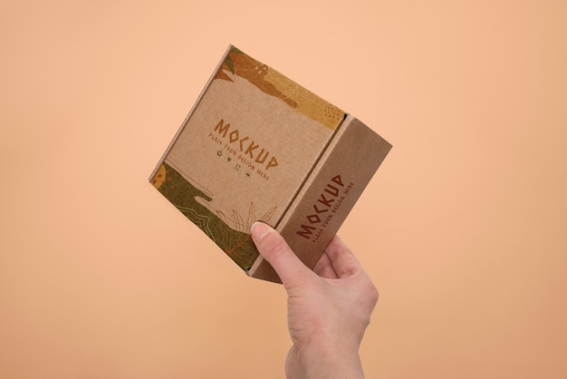 Hand holding box mockup