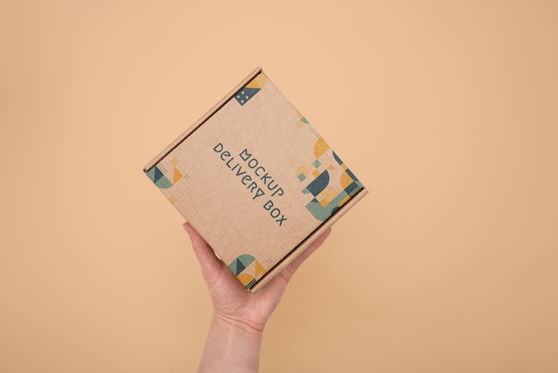 PSD hand holding box mockup