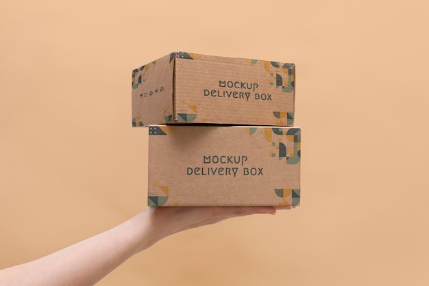 PSD hand holding boxes mockup