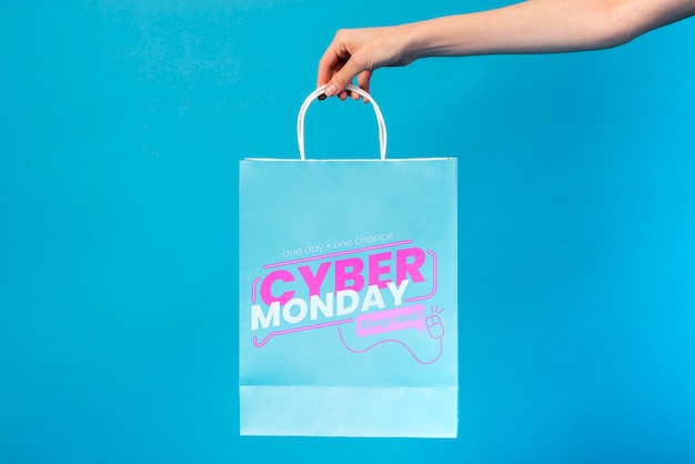 PSD hand holding a cyber monday paper bag