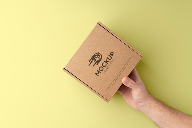 PSD hand holding delivery box flat lay