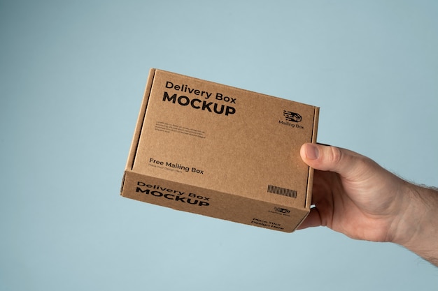 PSD hand holding delivery package mockup